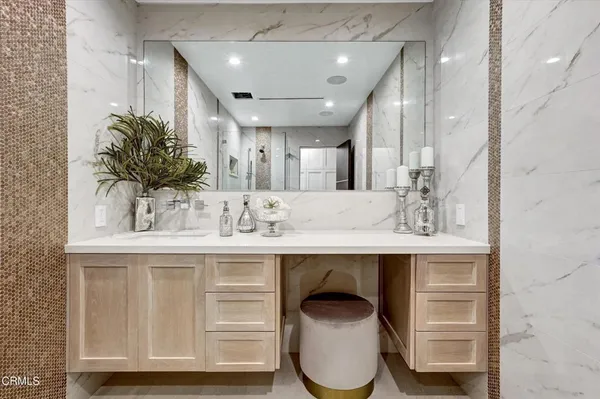 a view of a white house with a lawn chairs and a flat screen tv