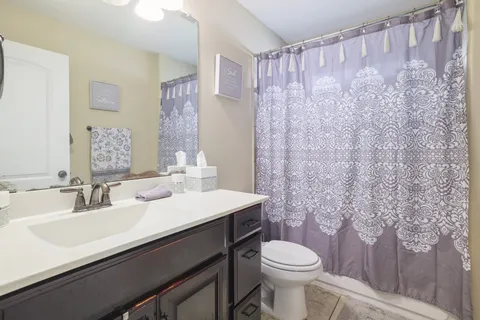 a bathroom with a sink a toilet and a mirror