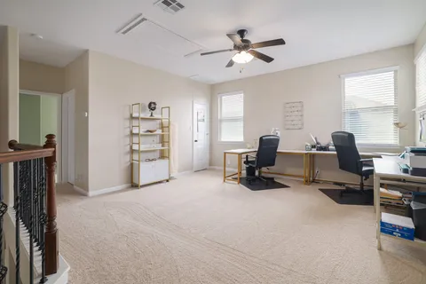 a view of a livingroom with workspace and a window