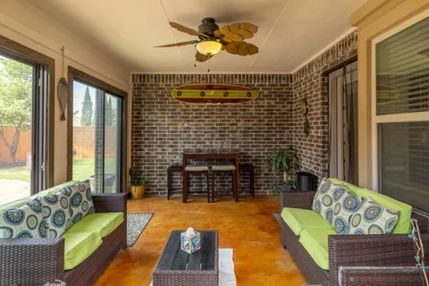 a living room with furniture a rug and a fireplace