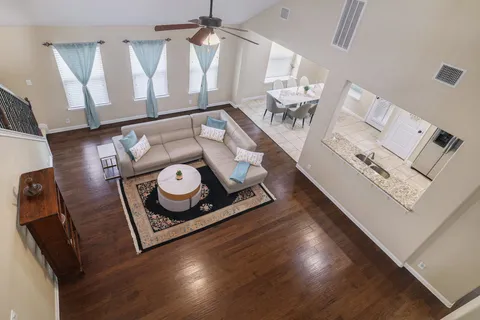 a living room with furniture and a wooden floor