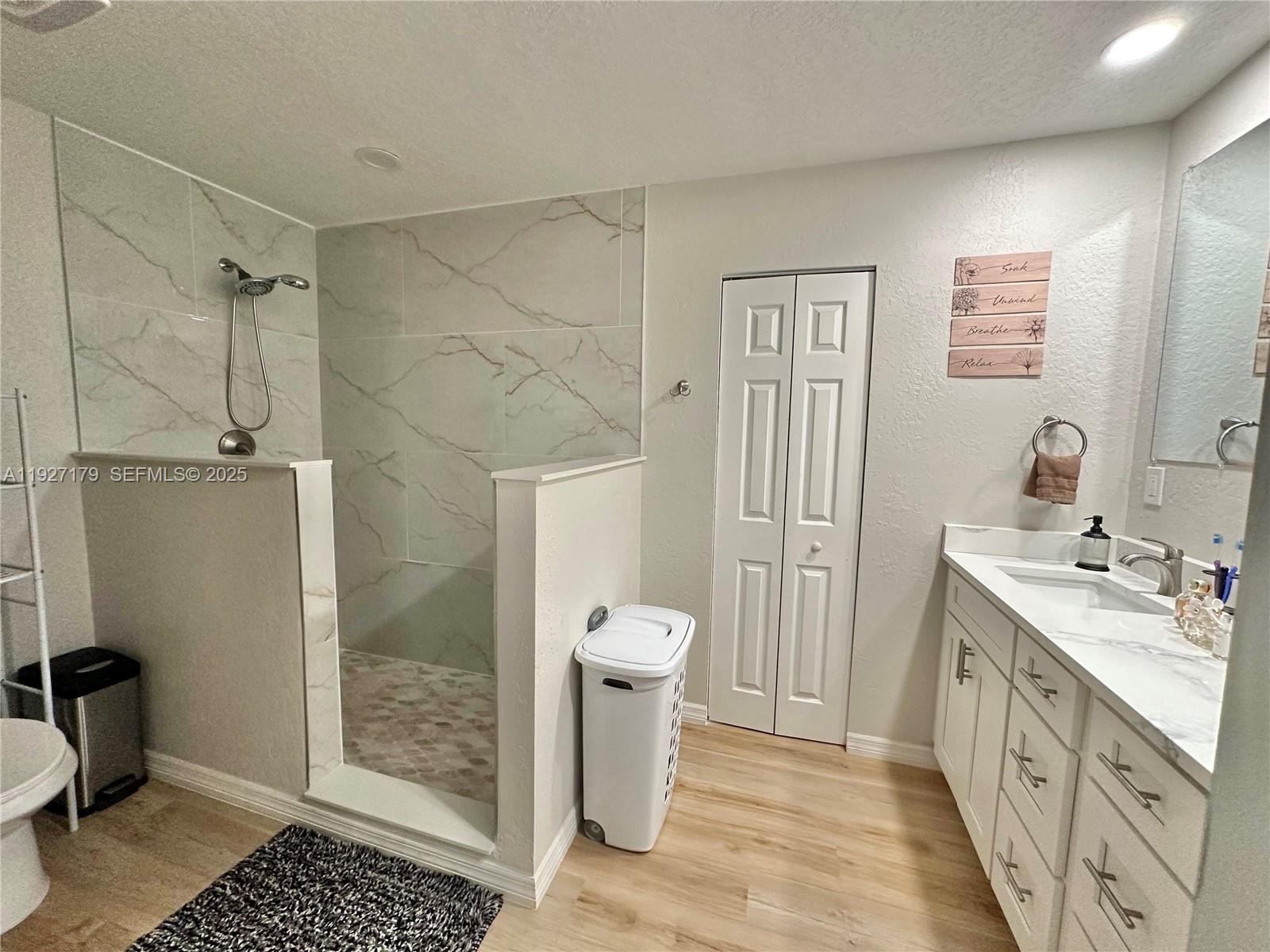 6525 Southwest 138th Terrace Ocala, FL 34481 - Photo 25 of 34 a bathroom with a granite countertop sink a toilet and shower