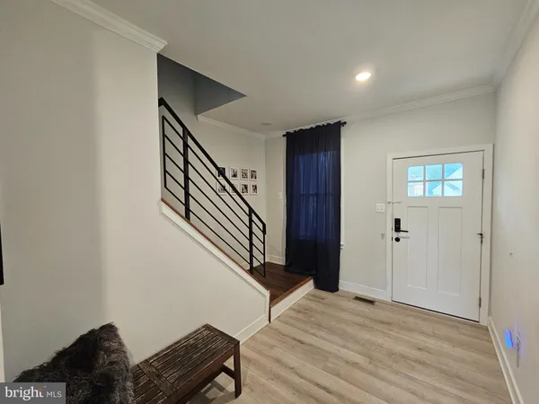 a view of a livingroom with wooden floor and stairs