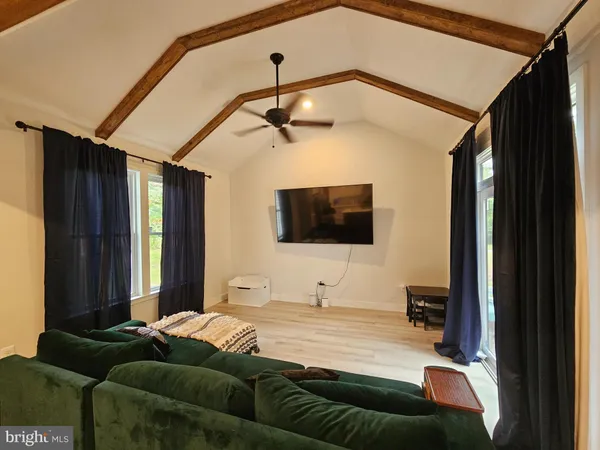 a bedroom with a bed window and flat screen tv