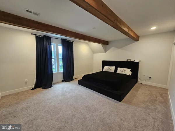 a bedroom with a bed and a mirror
