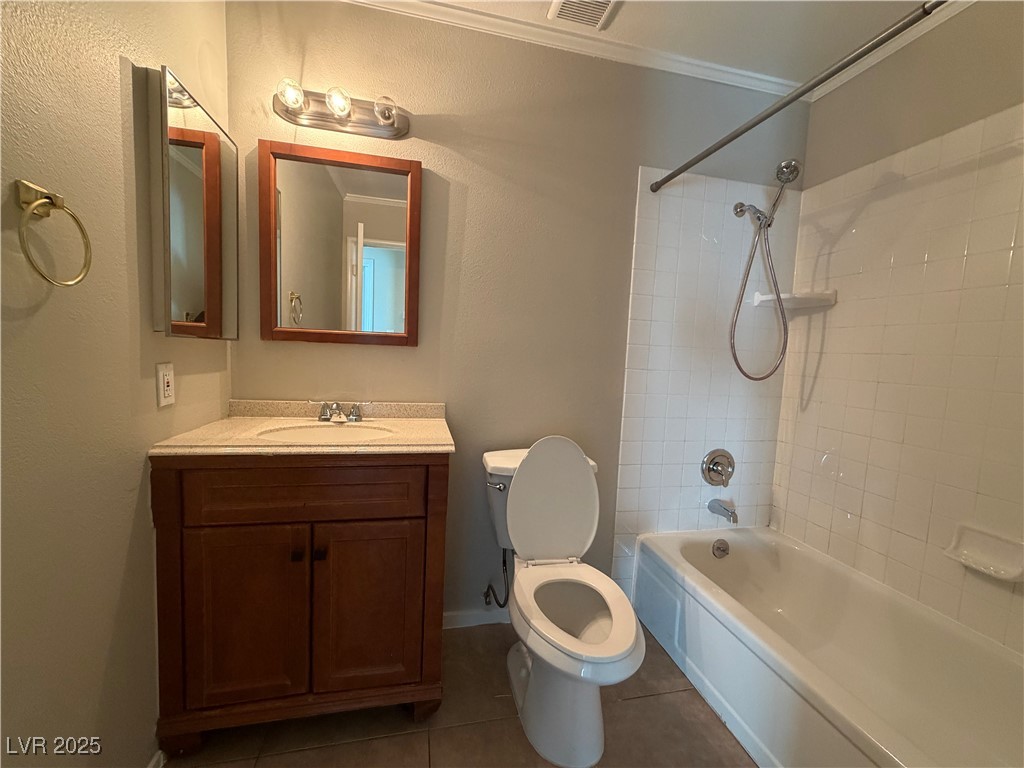 6401 Waterthrush Way Las Vegas, NV 89103 - Photo 16 of 19 Bathroom with shower / bathtub combination, vanity, dark tile patterned flooring, crown molding, and a textured wall