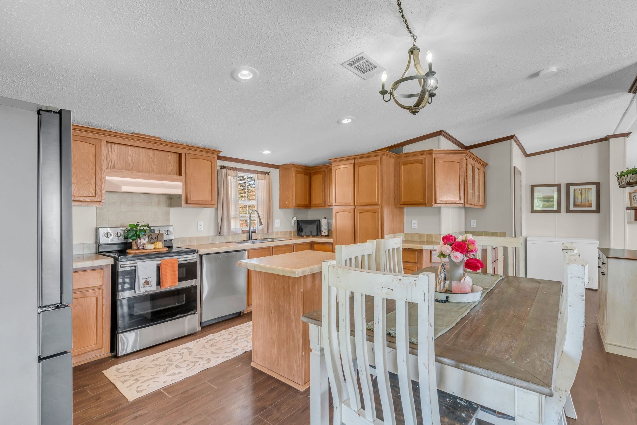 2309 West Mt Vernon Road Bethpage, TN 37022 - Photo 10 of 33 a living room with stainless steel appliances kitchen island granite countertop a dining table and chairs with wooden floor
