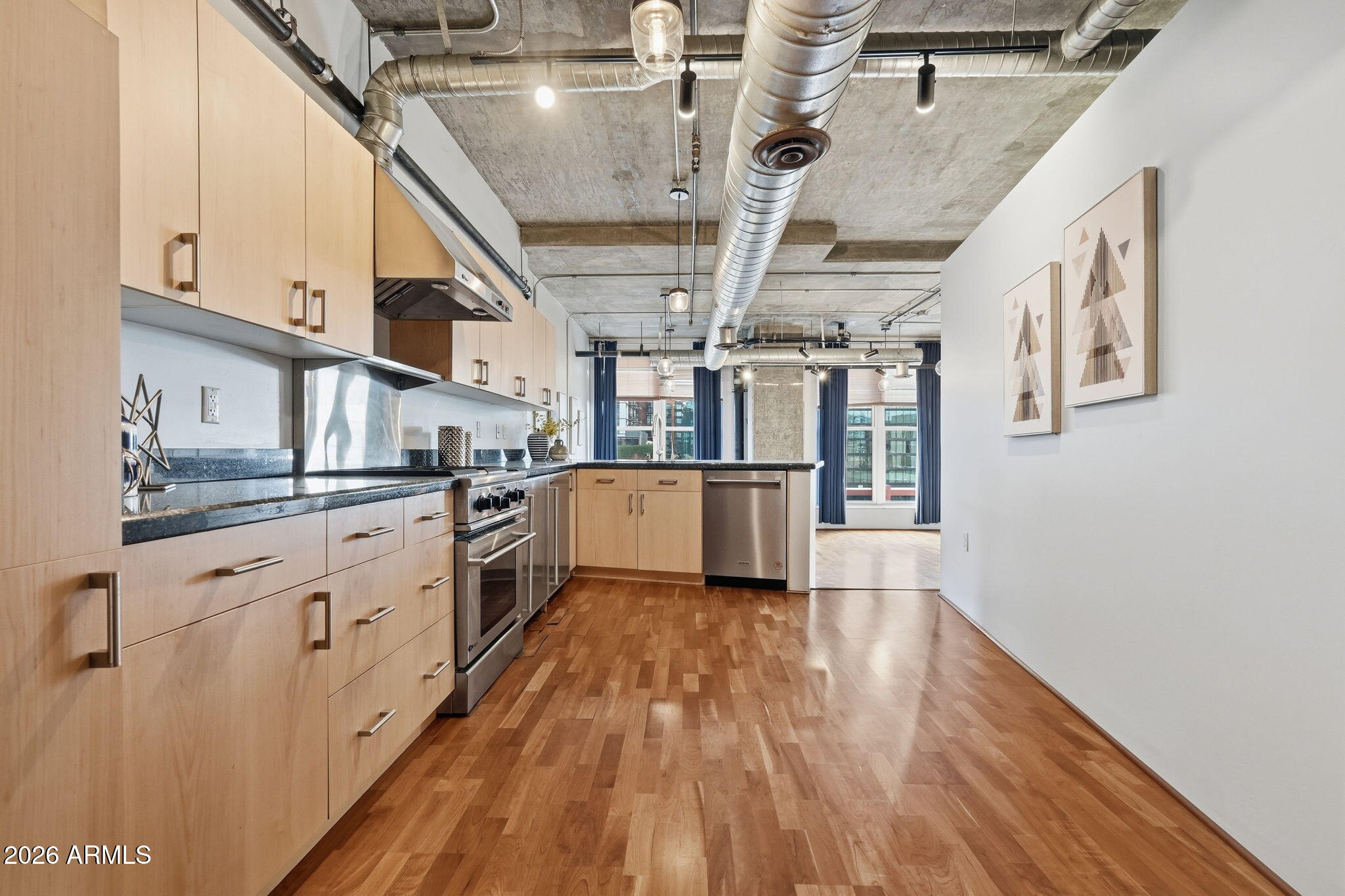 21 East 6th Street, Unit 608 Tempe, AZ 85281 - Photo 2 of 25 a large kitchen with cabinets a sink and wooden floor