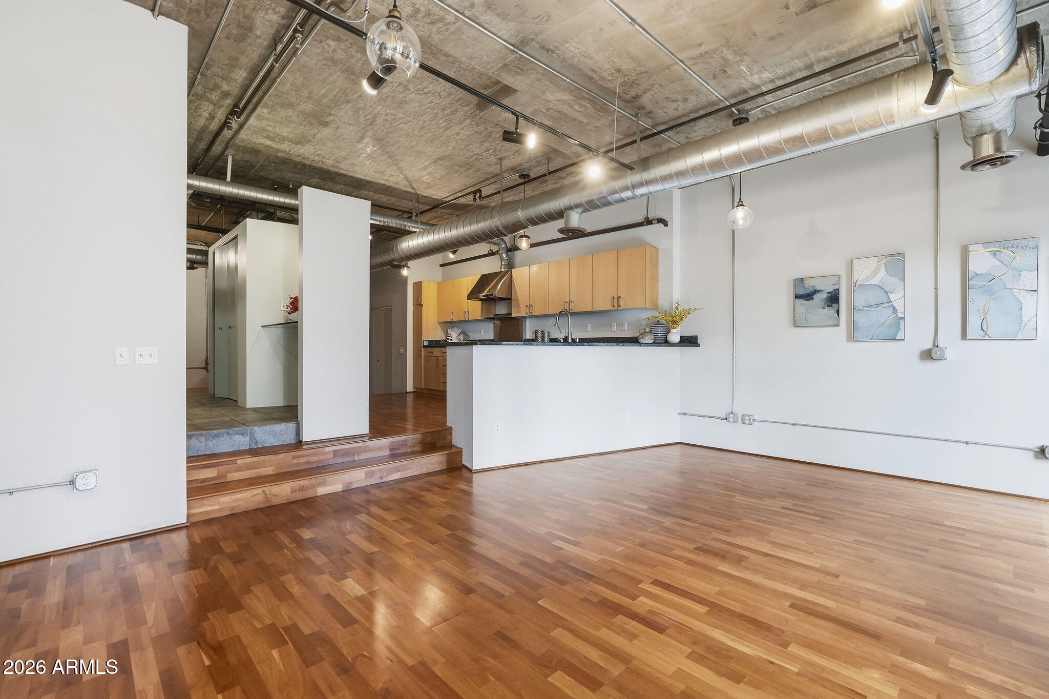 21 East 6th Street, Unit 608 Tempe, AZ 85281 - Photo 7 of 25 a view of a livingroom with wooden floor and a ceiling fan