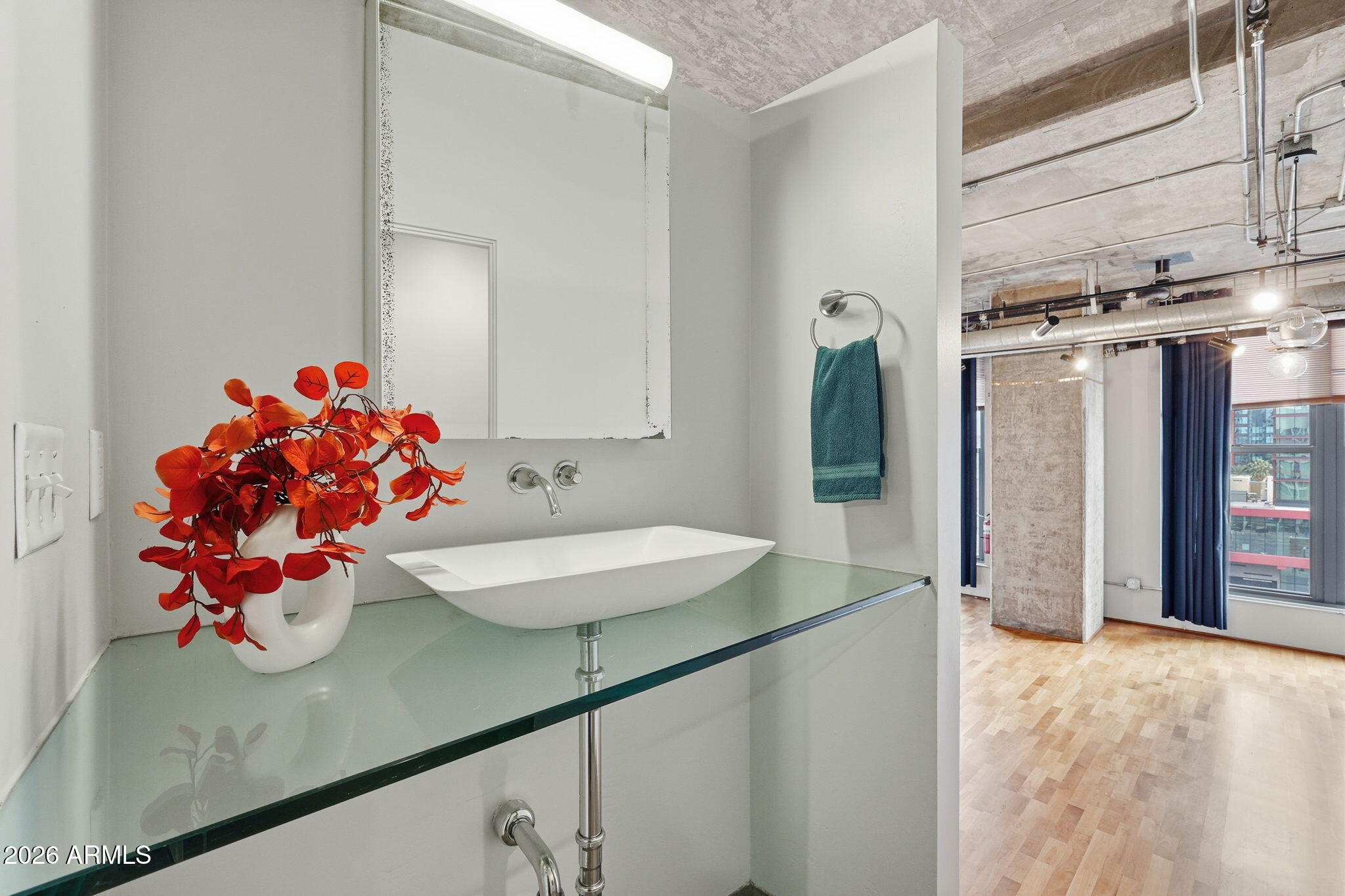 21 East 6th Street, Unit 608 Tempe, AZ 85281 - Photo 9 of 25 a bathroom with a sink mirror and vanity