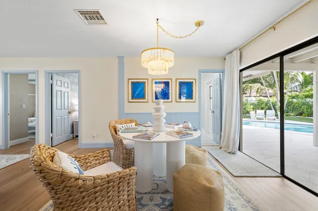 a living room with furniture and a large mirror