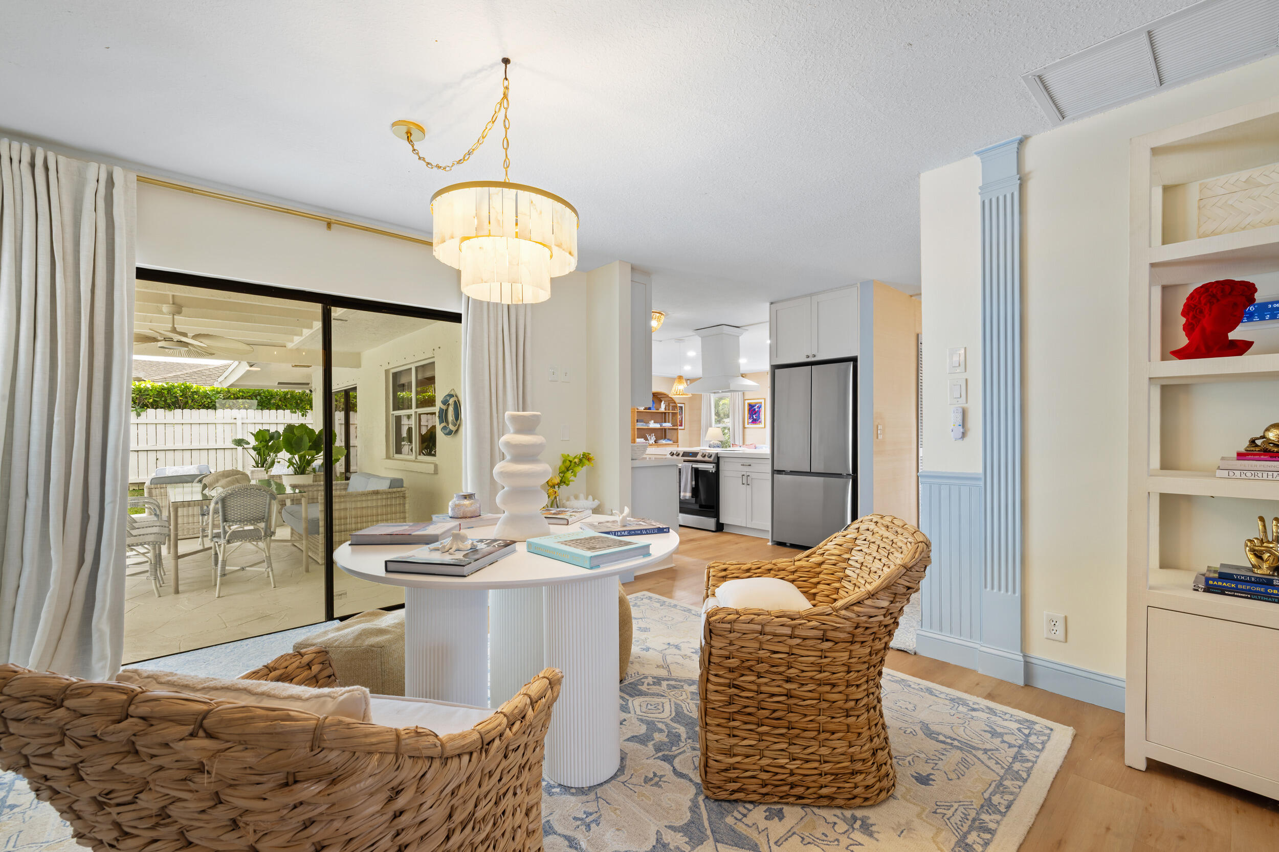 2512 Southwest 5th Street Boynton Beach, FL 33435 - Photo 12 of 37 a dining room with furniture a chandelier and wooden floor