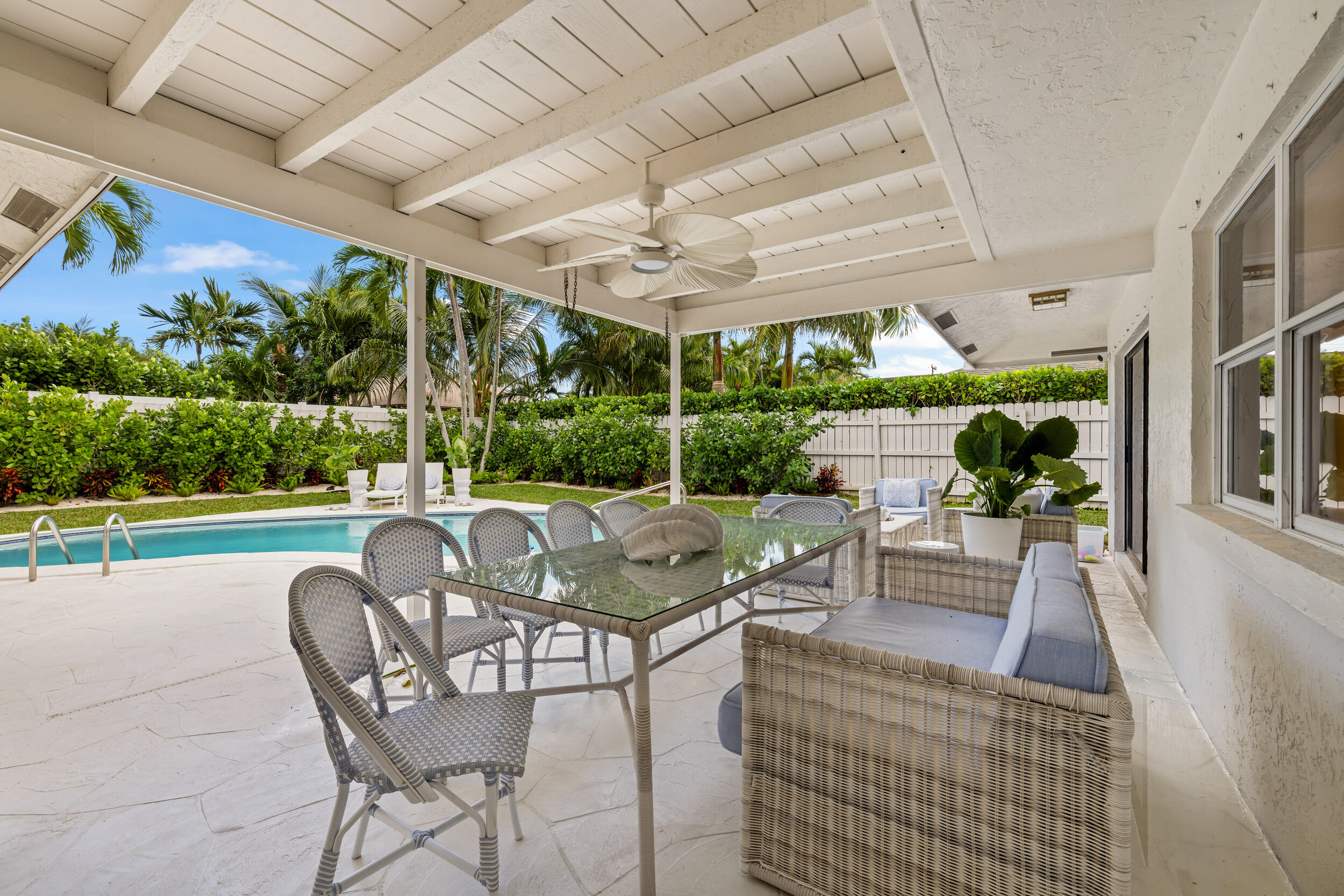 2512 Southwest 5th Street Boynton Beach, FL 33435 - Photo 23 of 37 a view of a patio with couches table and chairs with wooden floor and fence