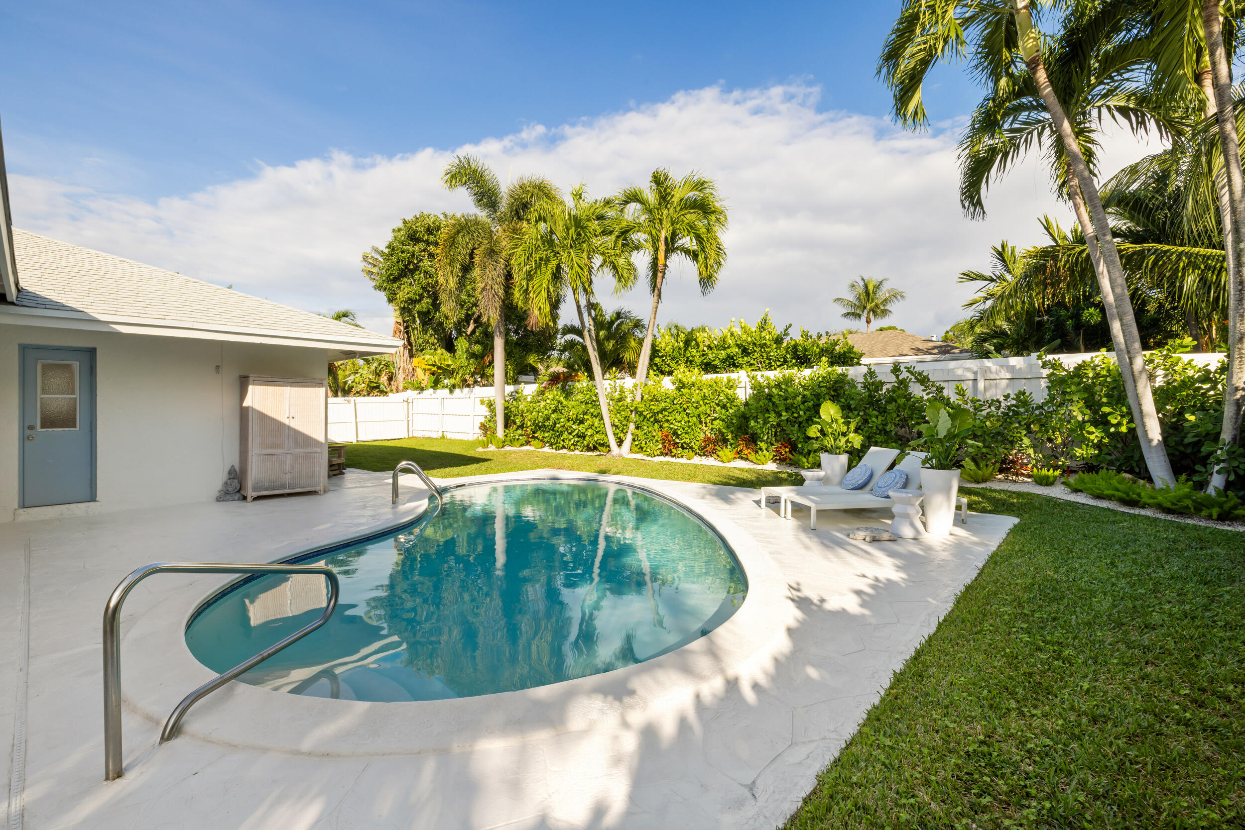 2512 Southwest 5th Street Boynton Beach, FL 33435 - Photo 25 of 37 a view of a swimming pool with a yard and potted plants