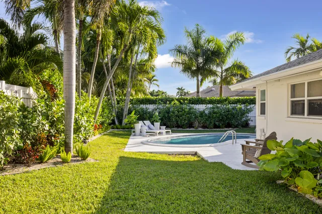 a view of backyard with swimming pool