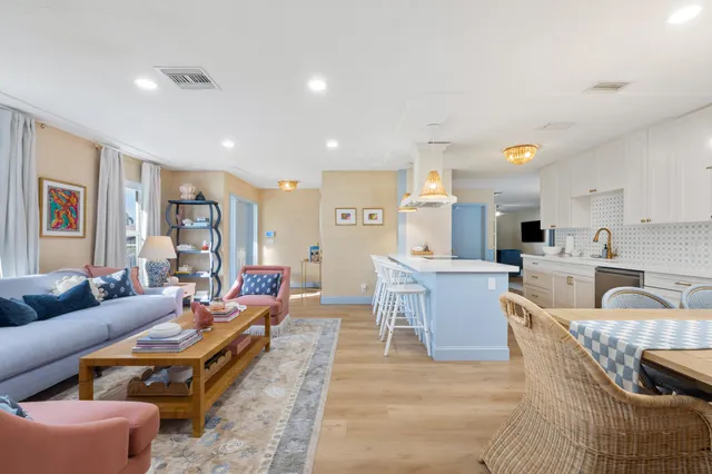 a living room with furniture and view of kitchen