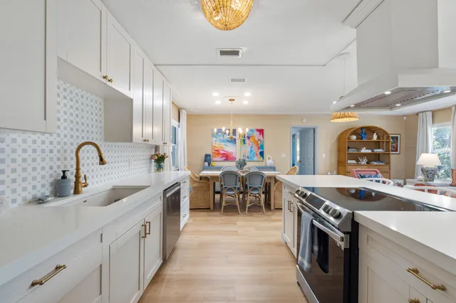 a kitchen that has a lot of cabinets in it and a sink