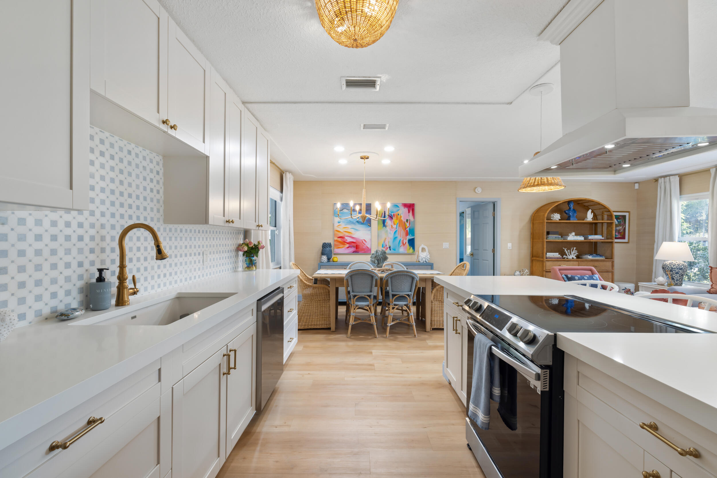 2512 Southwest 5th Street Boynton Beach, FL 33435 - Photo 7 of 37 a kitchen that has a lot of cabinets in it and a sink