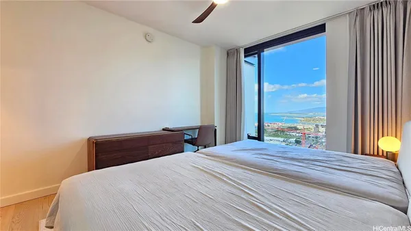 a bedroom with a large bed and a large window