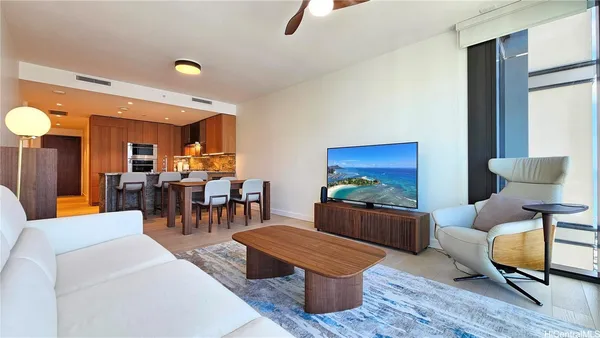 a living room with furniture and wooden floor