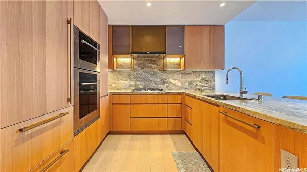 a kitchen with stainless steel appliances a sink and cabinets