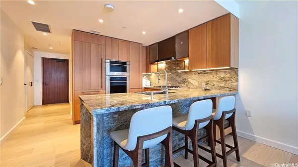 a dining room with furniture a window and kitchen view