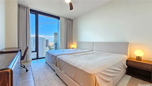 a bedroom with a bed and lamps