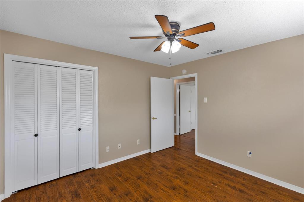 625 Deer Drive Greenville, TX 75402 - Photo 17 of 29 a view of a big room with wooden floor and windows