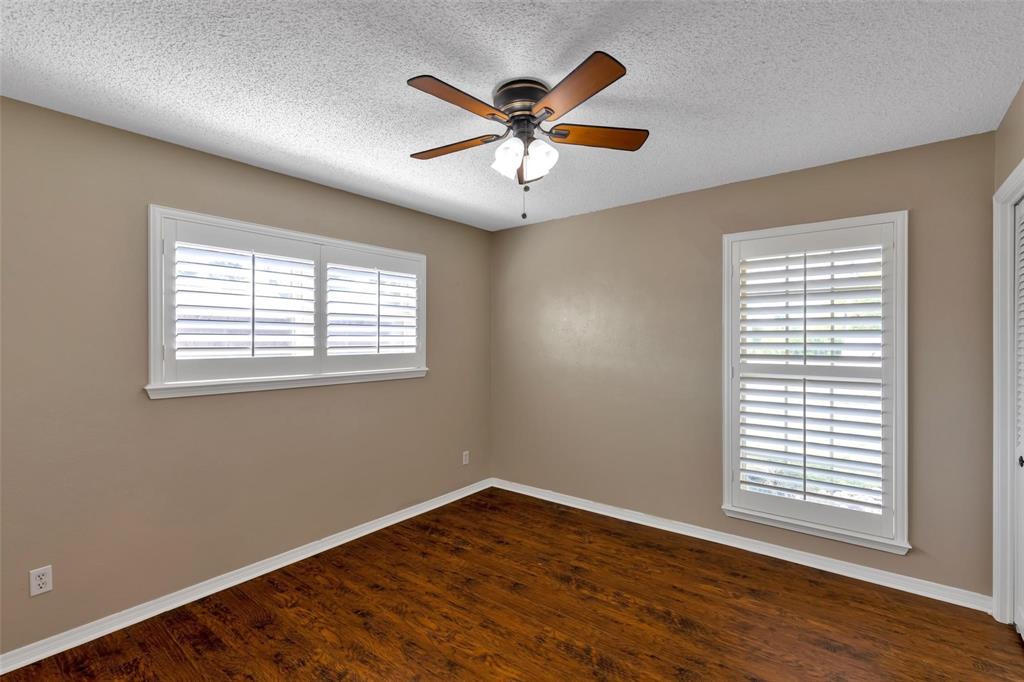 625 Deer Drive Greenville, TX 75402 - Photo 18 of 29 a view of an empty room with wooden floor and a window