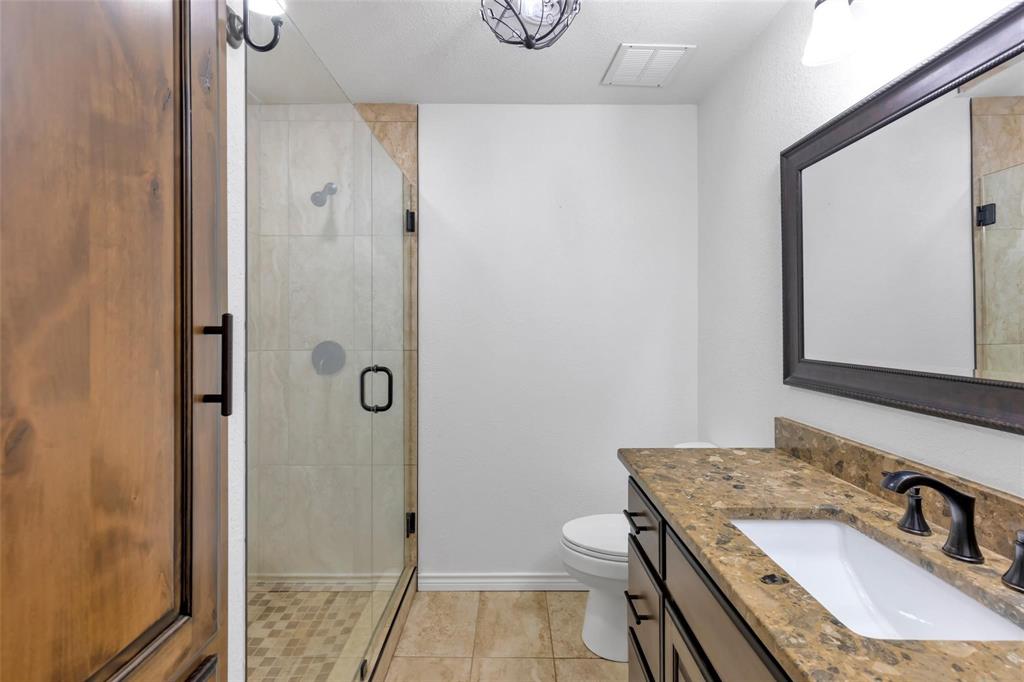 625 Deer Drive Greenville, TX 75402 - Photo 19 of 29 a bathroom with a granite countertop sink and a mirror