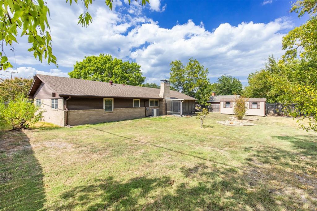 625 Deer Drive Greenville, TX 75402 - Photo 25 of 29 a front view of a house with a yard and garage