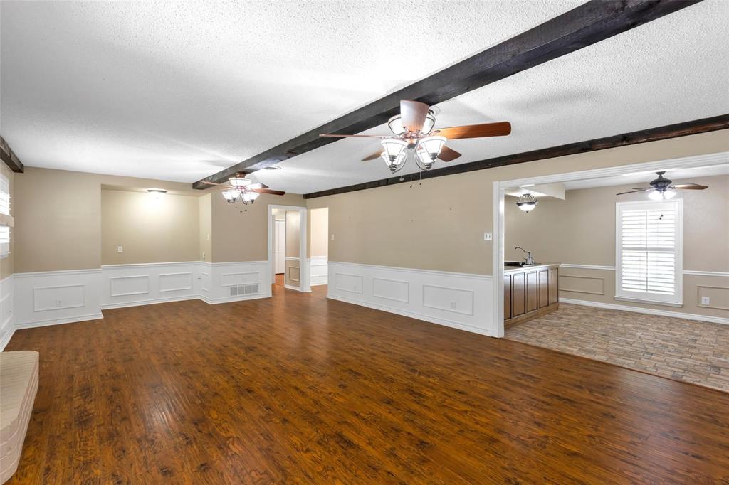625 Deer Drive Greenville, TX 75402 - Photo 5 of 29 a view of an empty room with wooden floor and a window