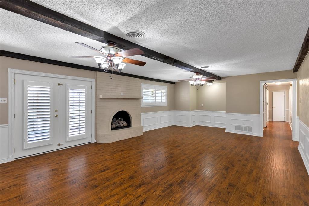 625 Deer Drive Greenville, TX 75402 - Photo 6 of 29 a view of an empty room with wooden floor and a window