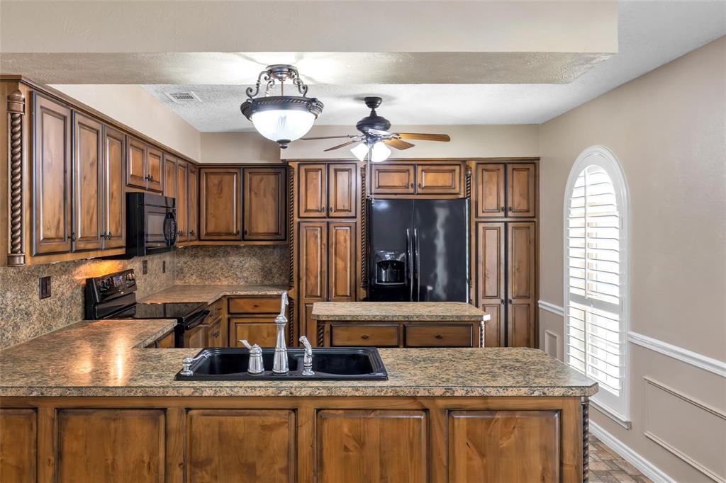 625 Deer Drive Greenville, TX 75402 - Photo 9 of 29 a kitchen with granite countertop a sink and a window