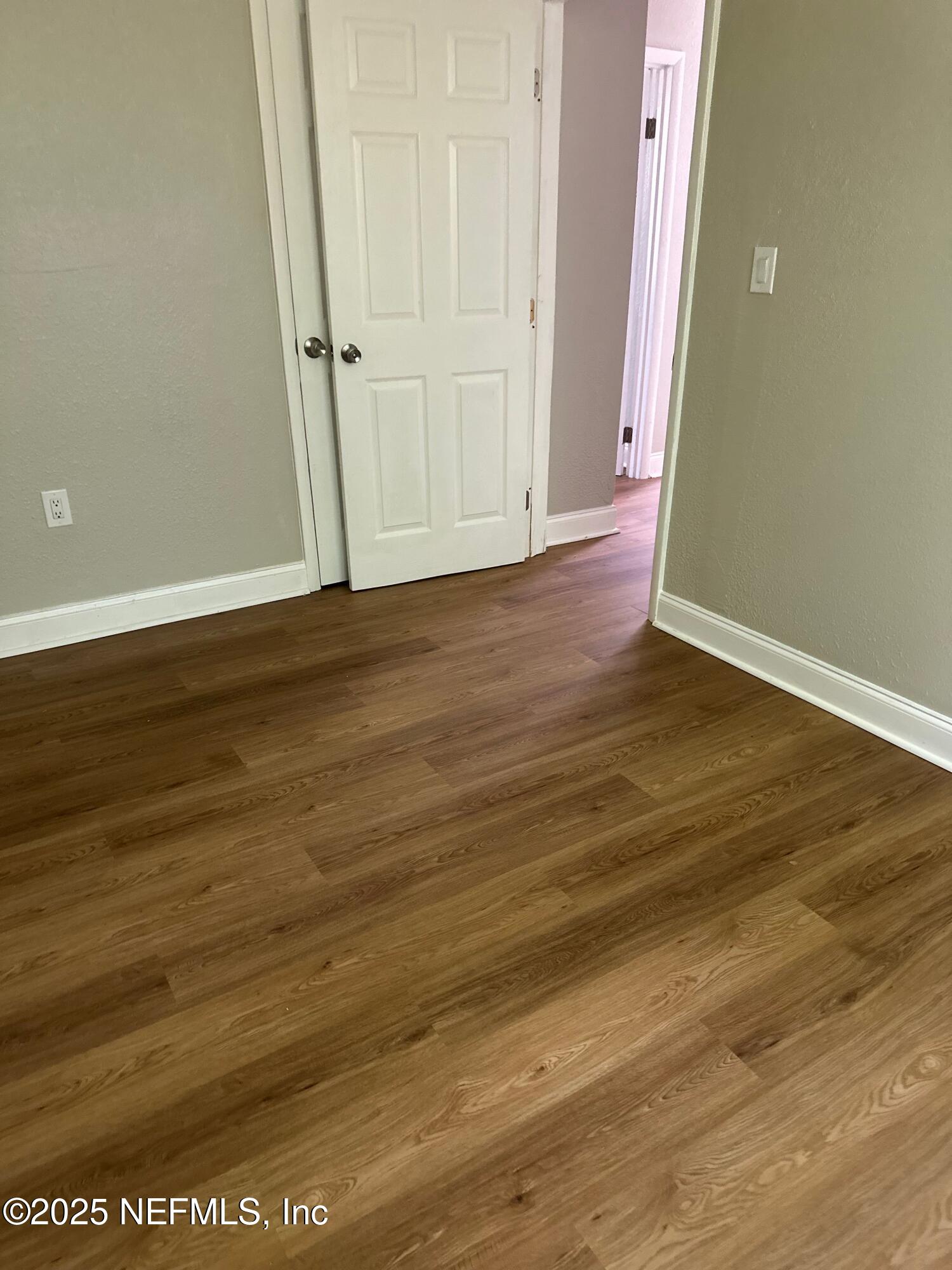 3615 Charles Street Jacksonville, FL 32209 - Photo 5 of 13 an empty room with wooden floor