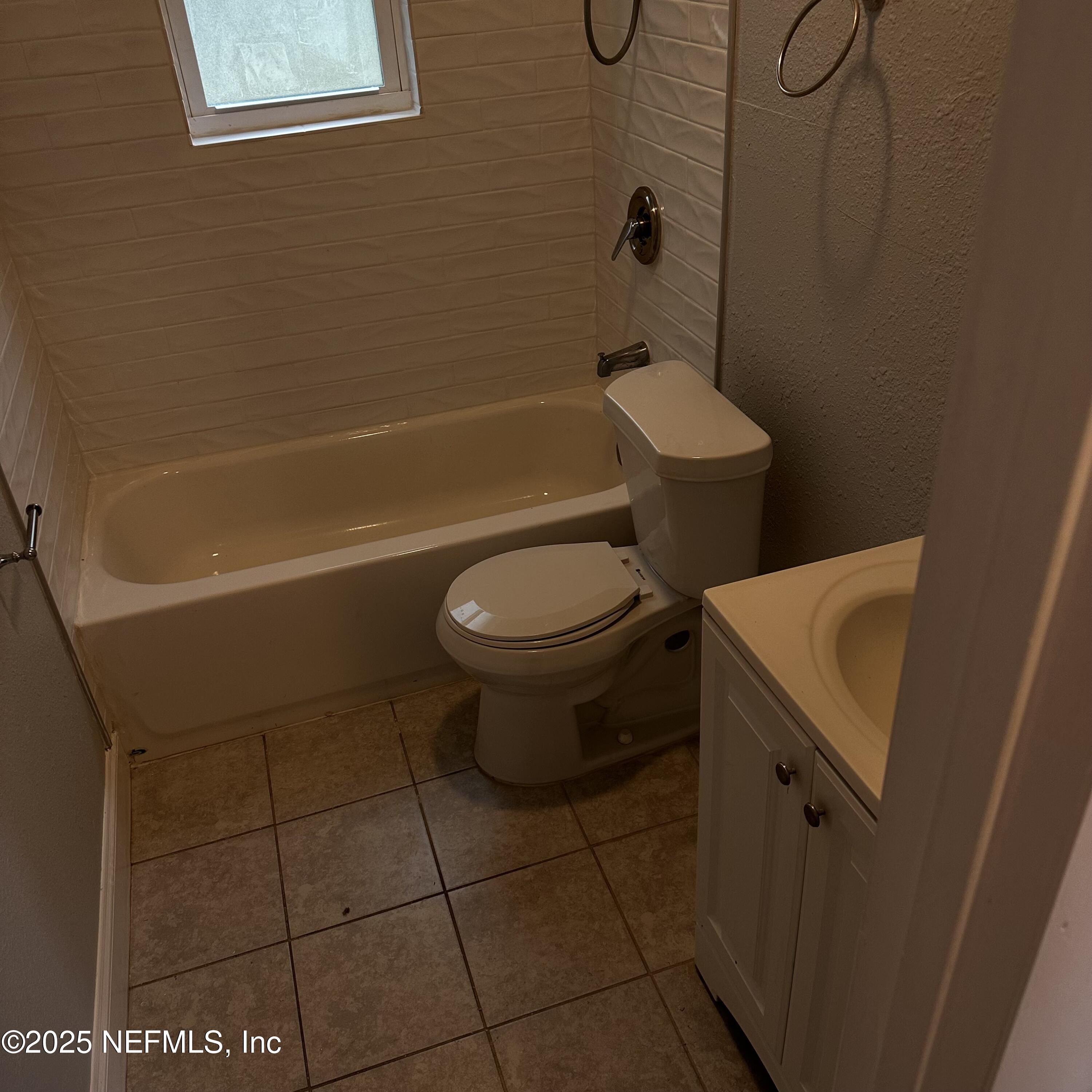 3615 Charles Street Jacksonville, FL 32209 - Photo 6 of 13 a bathroom with a toilet and a bath tub