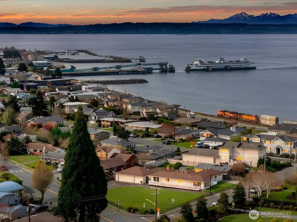 an aerial view of a building with outdoor space and lake view