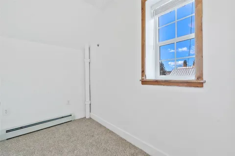 a view of a small space with wooden floor