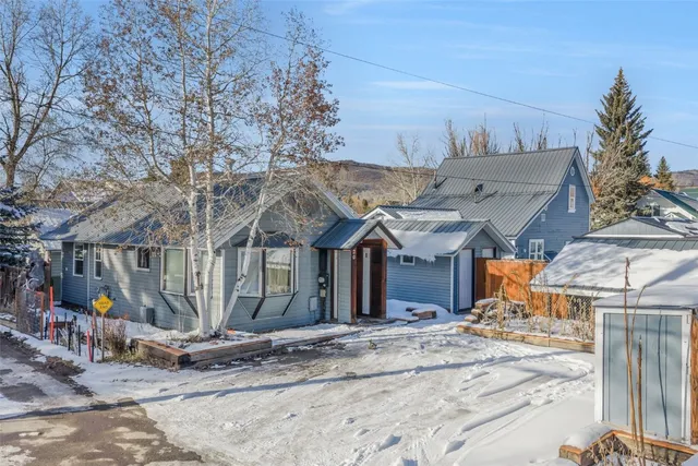 an aerial view of a house with a mountain