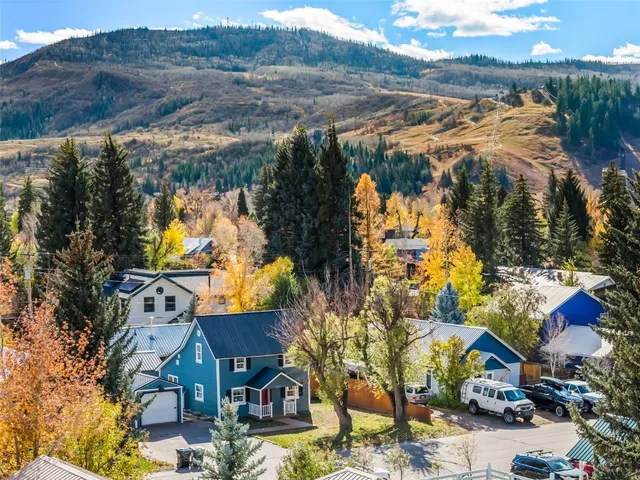 an aerial view of residential houses with outdoor space