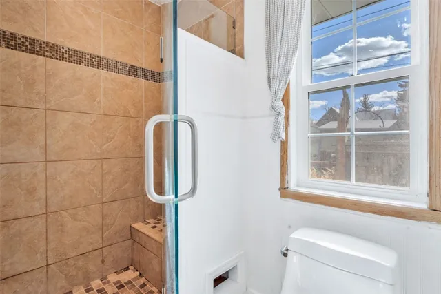 a view of a house with backyard and wooden fence