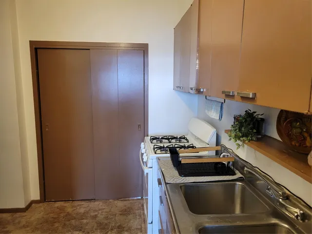 a kitchen with a sink and a refrigerator
