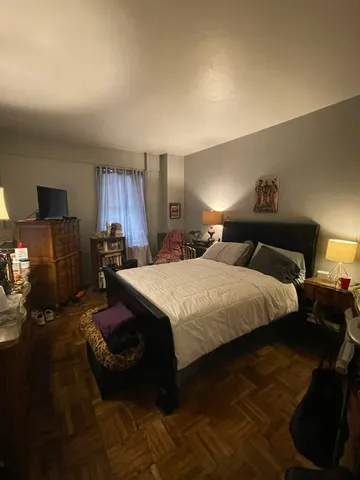 a bedroom with a bed and window