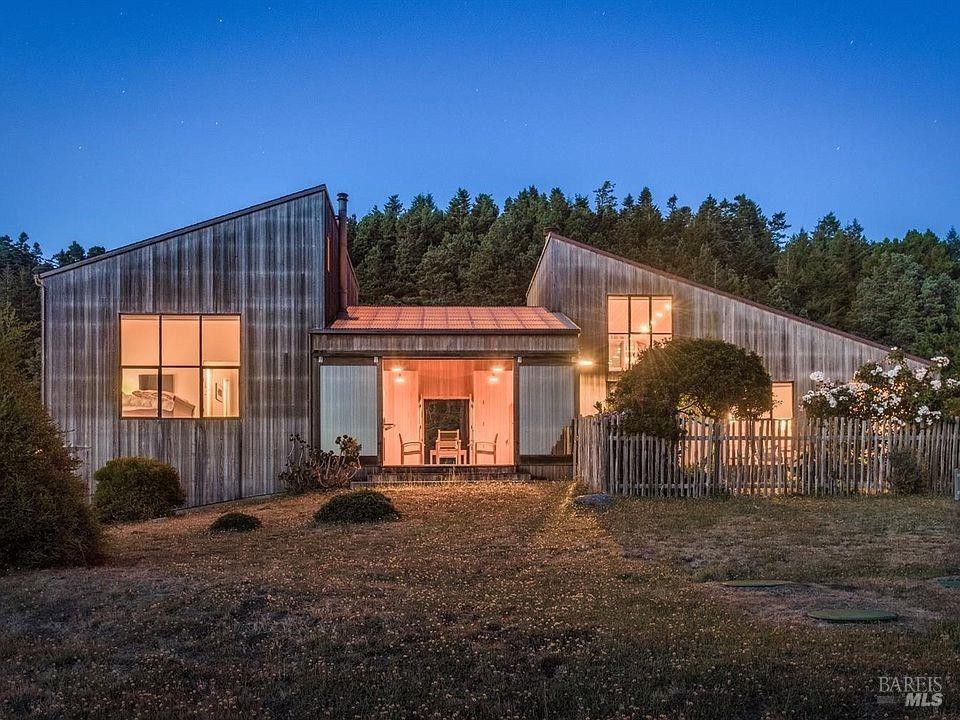 a view of a house with a backyard and a tree