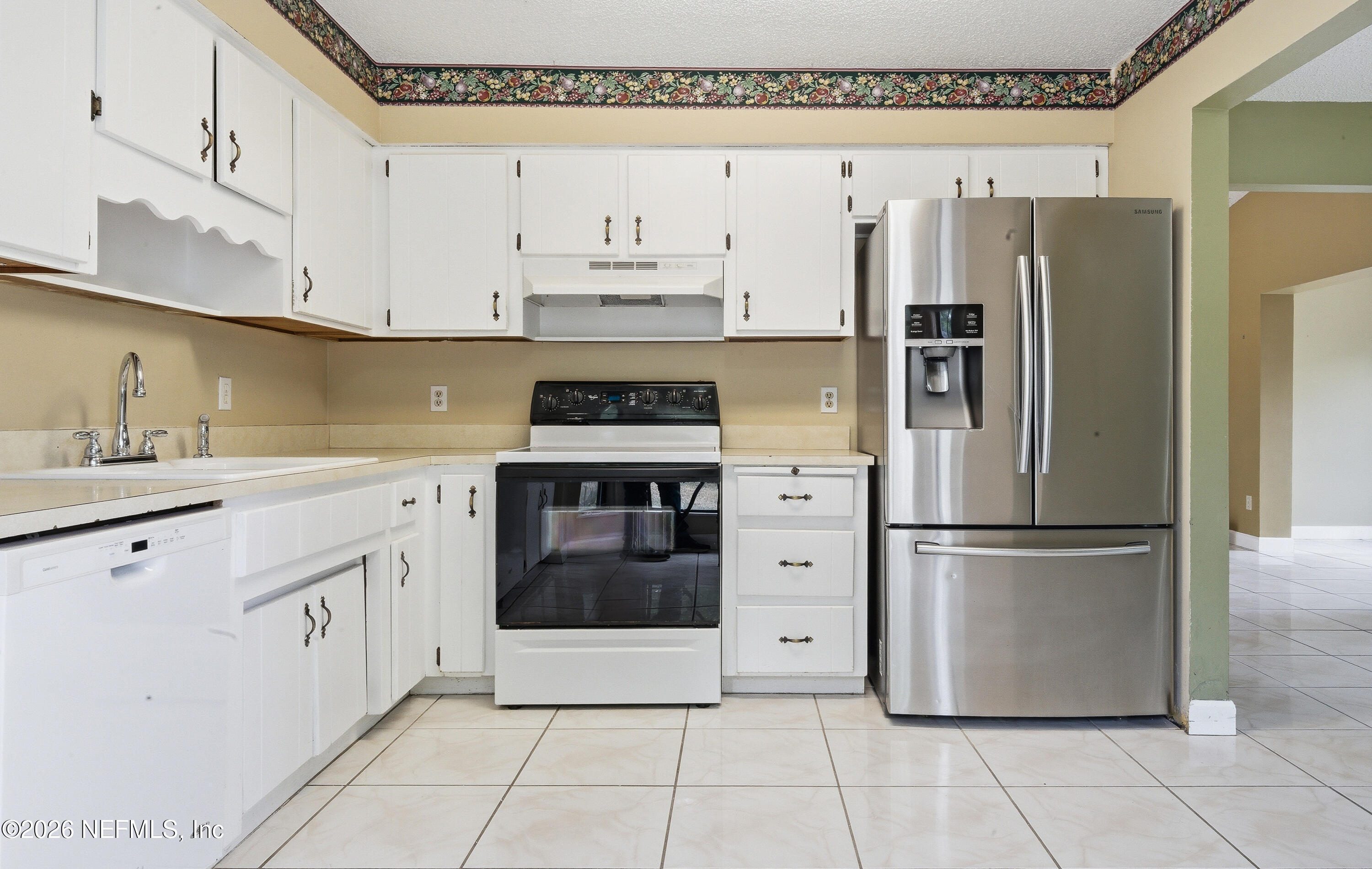 1722 Farm Way Middleburg, FL 32068 - Photo 11 of 37 a kitchen with stainless steel appliances a refrigerator sink and cabinets