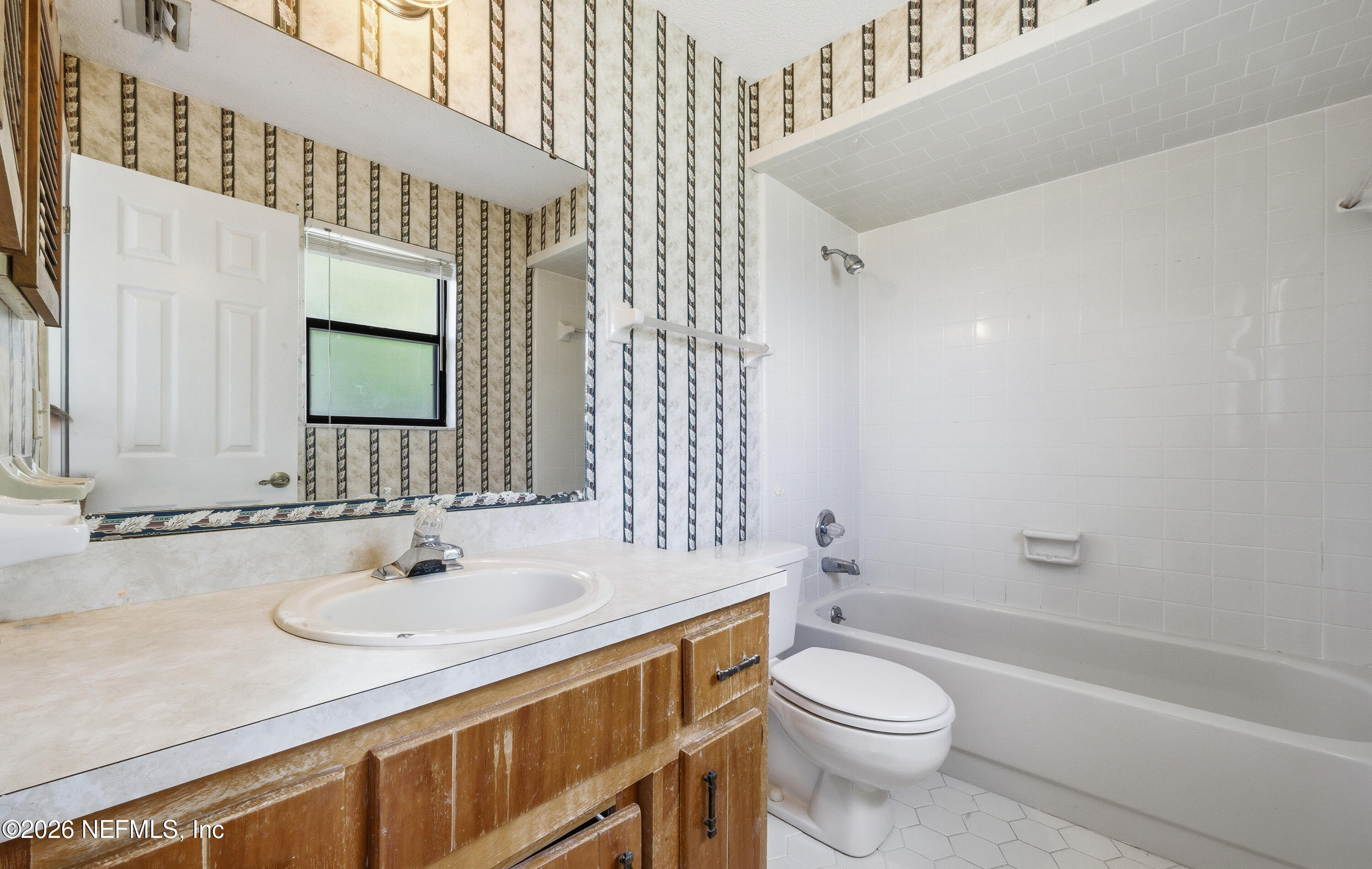 1722 Farm Way Middleburg, FL 32068 - Photo 17 of 37 a bathroom with a sink toilet a mirror and shower