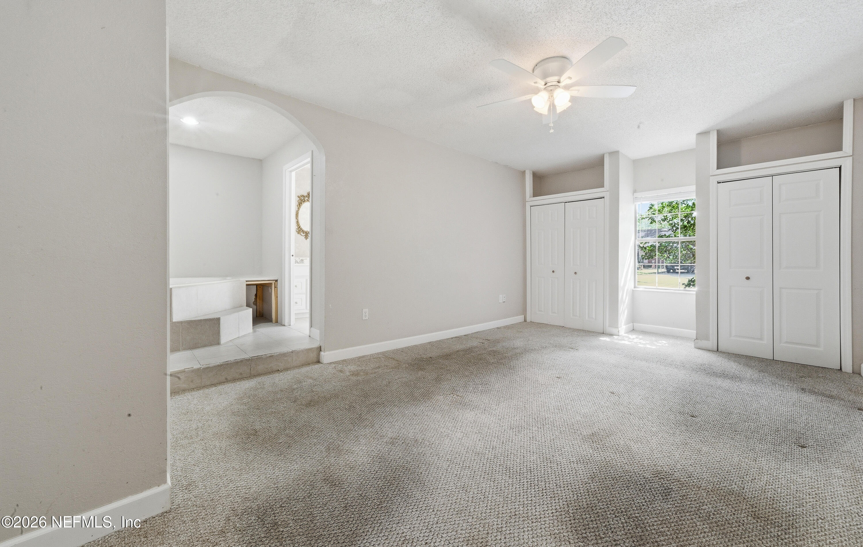 1722 Farm Way Middleburg, FL 32068 - Photo 18 of 37 an empty room with a white walls and a ceiling fan