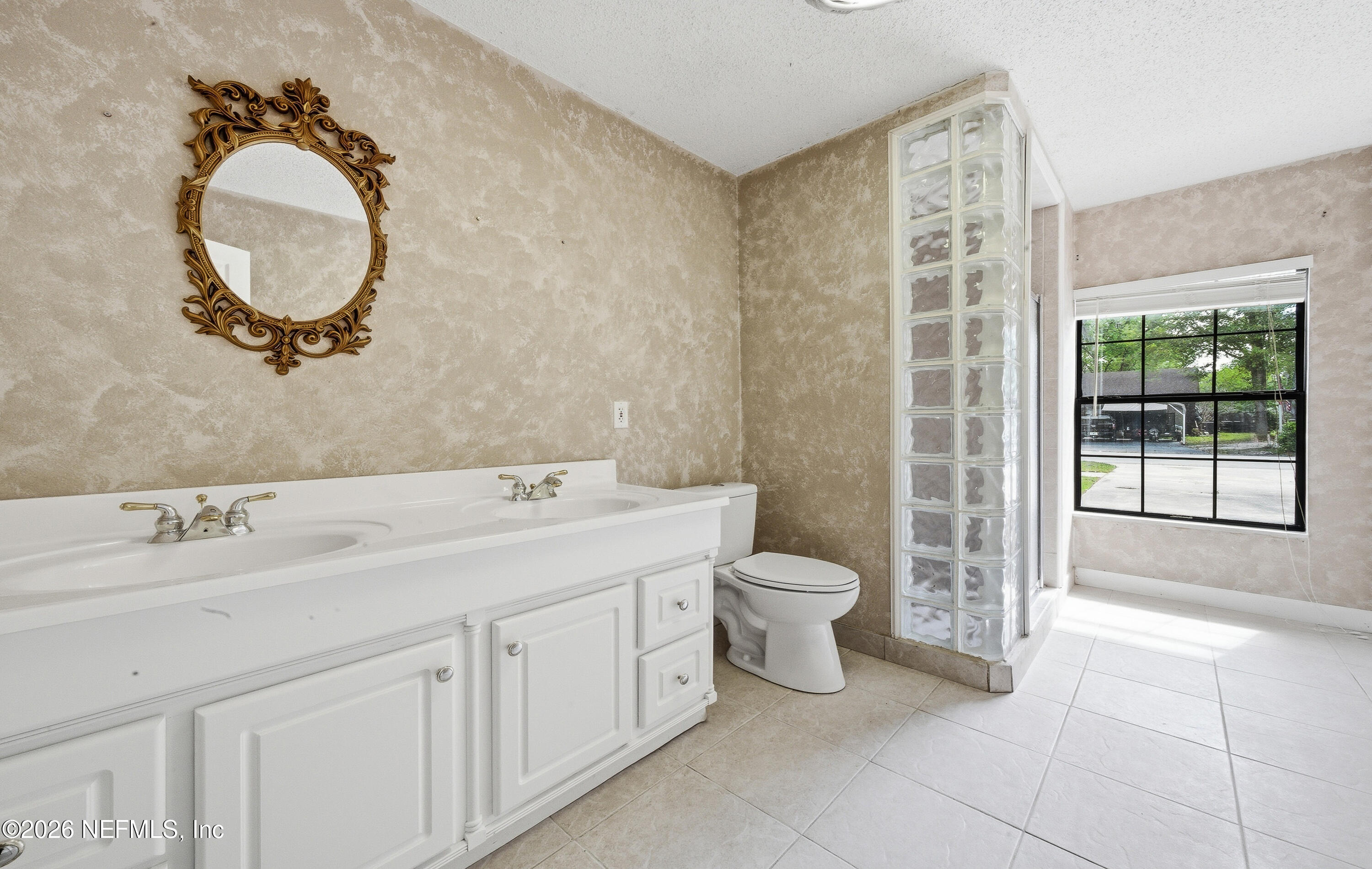1722 Farm Way Middleburg, FL 32068 - Photo 21 of 37 a spacious bathroom with a toilet sink and mirror