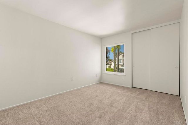 a patio with a table and chairs and potted plants