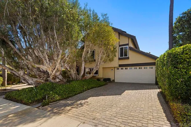 a view of an empty room with fireplace and a window